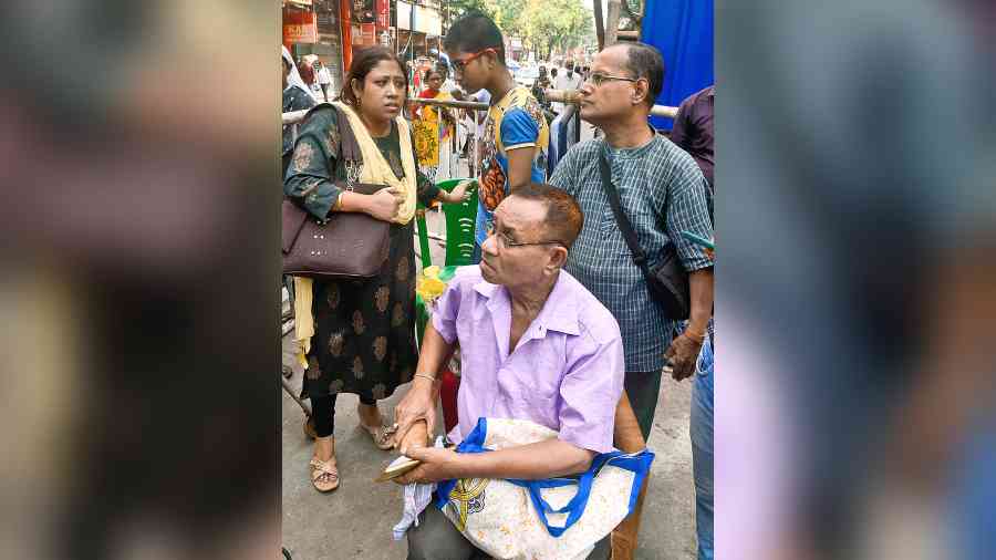 Displaced residents Nabanita Barua and her son Raunak (behind) with family members on Bowbazar’s Madan Dutta Lane on Saturday. 