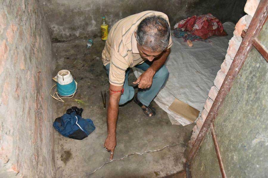 A resident of Bowbazar points to a crack on the floor of his house caused by water seepage during construction work for the East-West Metro corridor