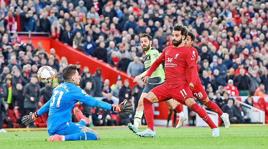 Liverpool’s Mohamed Salah (right) scores past Manchester City’s goalkeeper Ederson at Anfield on Sunday.