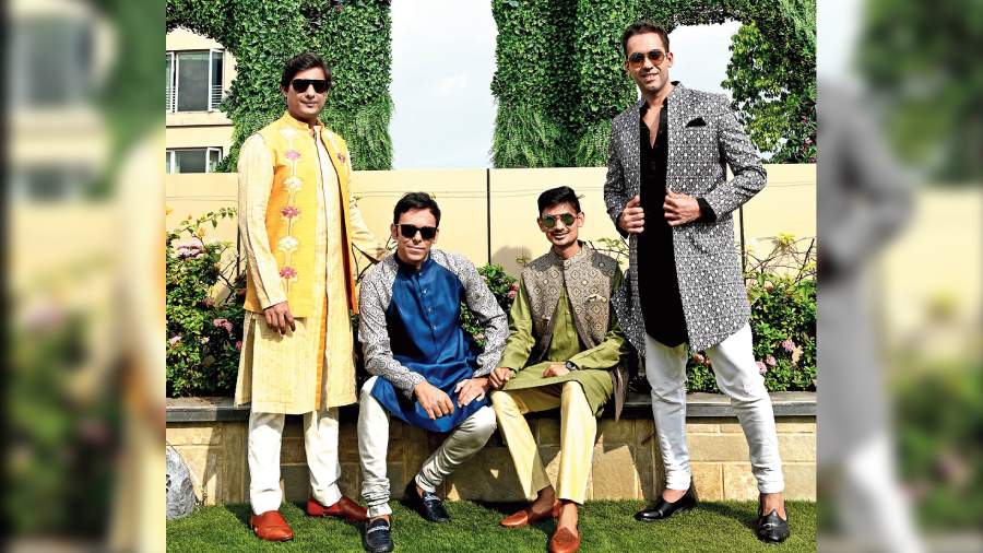 (L-R) While Nikhil Bhambani wore an open Nehru jacket over a shirt-style kurta in musky yellow, Kunal Bose channelled a blue kurta with printed wrangler sleeves and grey churidar. Ayush Sarda’s cut-away jacket over a pastel shade of green and straight pants matched the festive mood. Chintu Vij’s simple black linen kurta and white churidar got a glamorous uplift with a printed monotone open jacket and the Punjabi munda rocked the look.