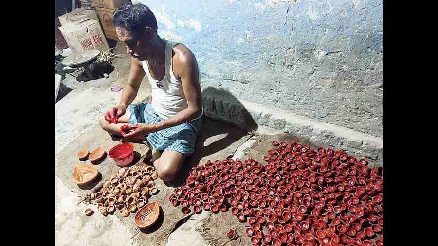 An artisan makes diyas in Ultadanga.
