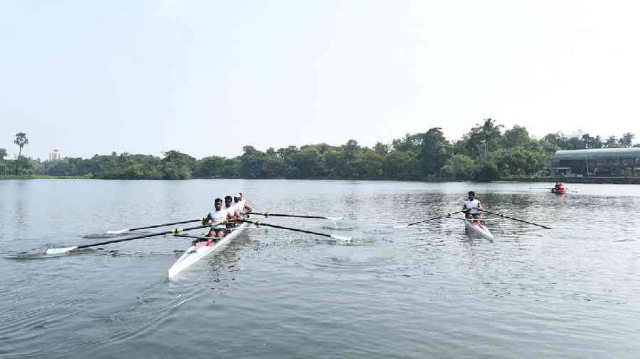 Rowers at Rabindra Sarobar on Thursday. A petrol-powered rescue boat (right) on the lake. Picture by Gautam Bose