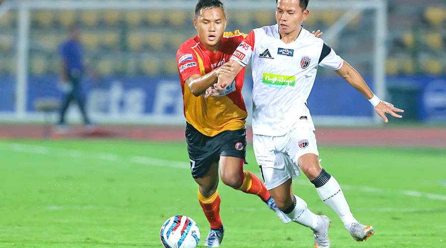 Jerry Lalrinzuala (left) of East Bengal and Rochharzela of NorthEast United battle for the ball during the ISL IX match in Guwahati on Thursday.