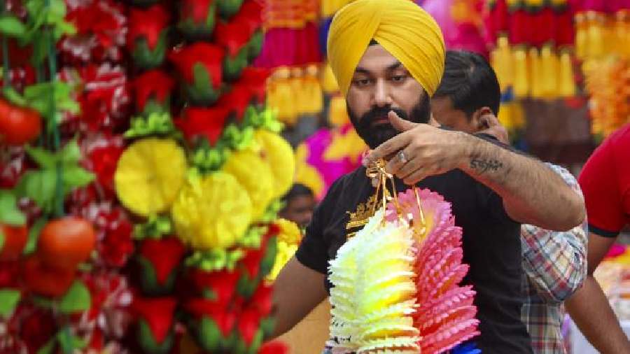 A customer looks at a decorative item displayed for sale at a shop ahead of the Diwali in Amritsar
