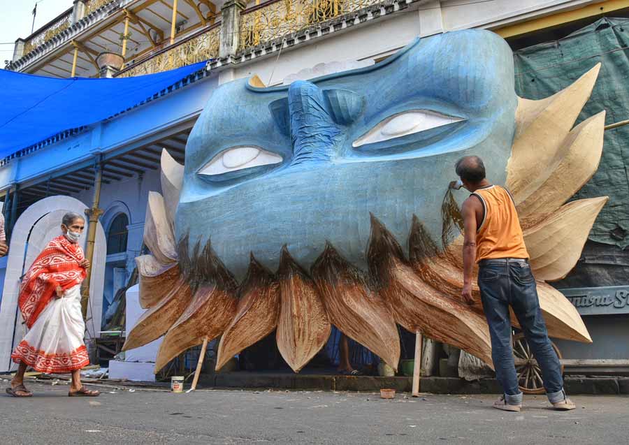 Labourers working against time to complete Kali Puja pandals at Dompara on Friday.