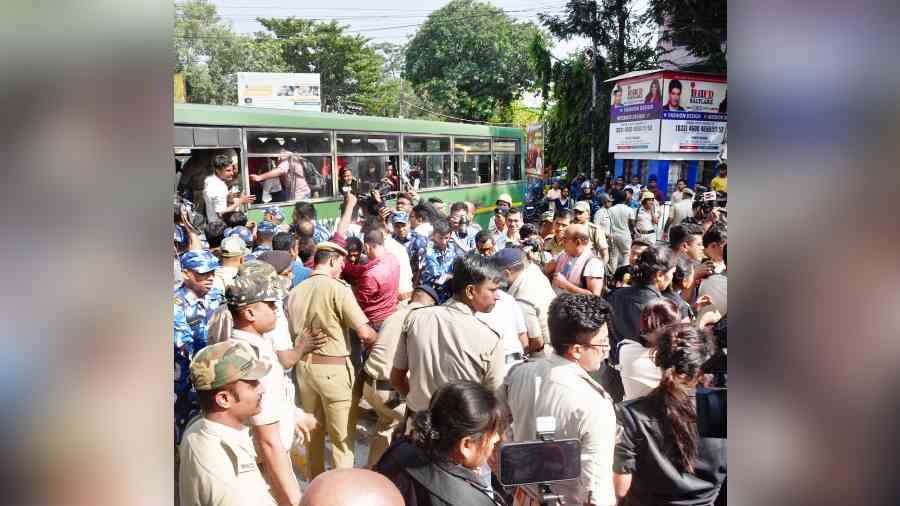 Protesters demonstrating against the ‘forcible’ removal of TET candidates being made to board a bus by police near City Centre in Salt Lake on Friday. 