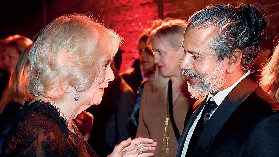Britain’s Queen Camilla speaks with shortlisted author Shehan Karunatilaka at the Booker Prize for Fiction 2022 awards ceremony in London. She would hand him the coveted prize later in the evening.