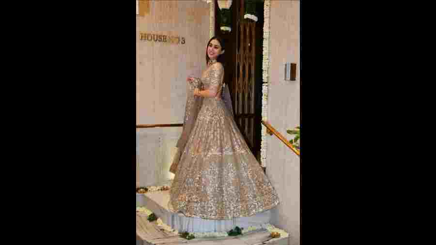 Sara Ali Khan looks dazzling in golden lehenga while posing for pictures at the Diwali bash. 