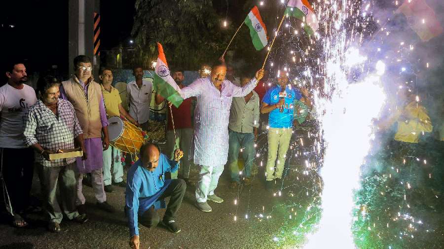  People celebrate after India won the ICC Men's T20 World Cup cricket match against Pakistan, in Bhopal on October 23. 