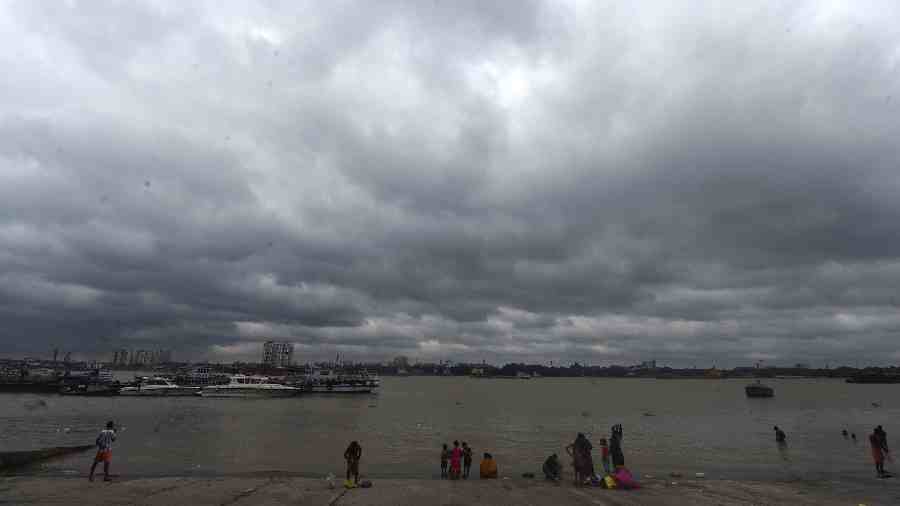 Dark clouds hover in the skies above the Ganga river owing to Cyclone Sitrang, in Calcutta