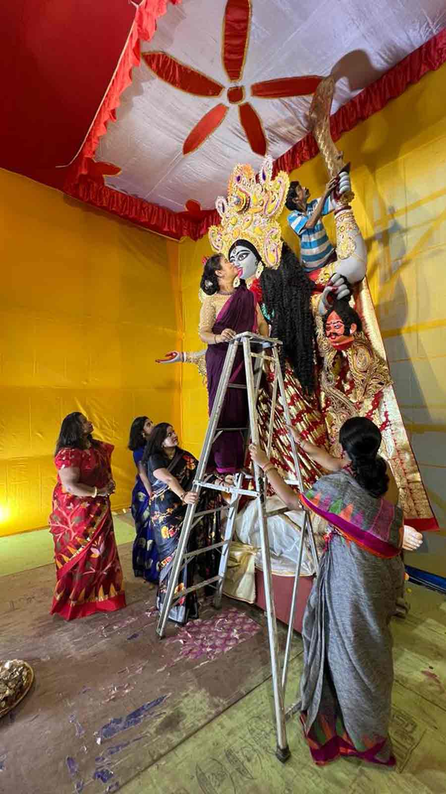 Women volunteers of Rajabagan Athletic Club busy with last-minute preparations at the Kali Puja pandal. The club at Hatibagan is celebrating its 78th year