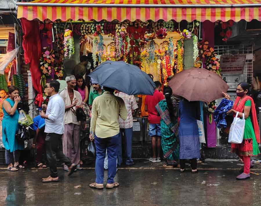 Diwali revellers negotiate with rain while they bargain with shopkeepers for  decorative items on Monday afternoon.