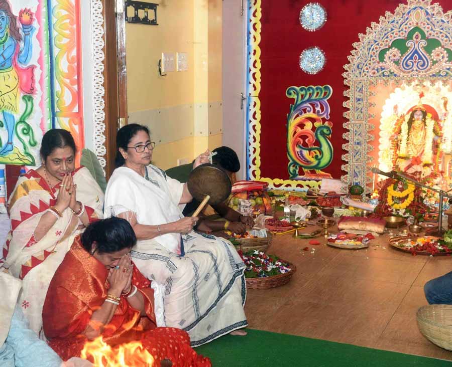 West Bengal Chief Minister Mamata Banerjee at the Kali Puja at her home on Monday. Hundreds of people gathered outside her residence on Harish Chatterjee Street to catch a glimpse of the rituals. The CM also prepared the bhog' (food offering to the goddess) and played host to scores of guests, which included VVIPs, cabinet colleagues, politicians, journalists and the common man. Clad in her trademark cotton saree, the chief minister greeted visitors with folded hands and requested everyone to have the bhog'. Kali Puja has been conducted at her home for the last four decades. 