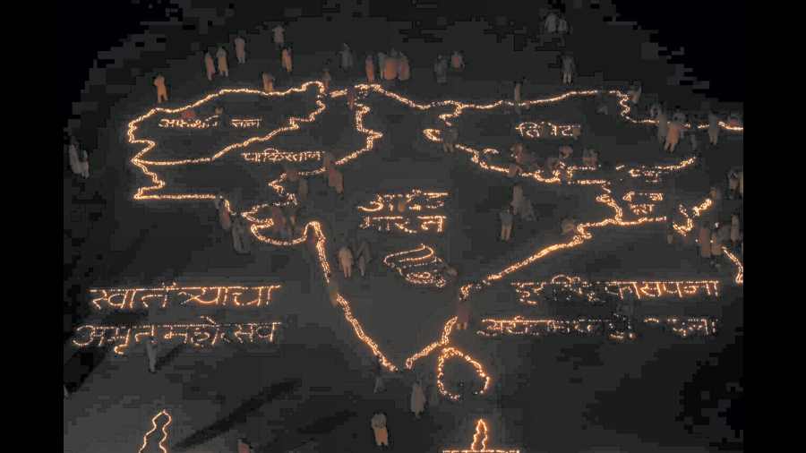 Members of Diya for Unity organisation make the geographical map of the Indian subcontinent with earthen lamps, in Navi Mumbai