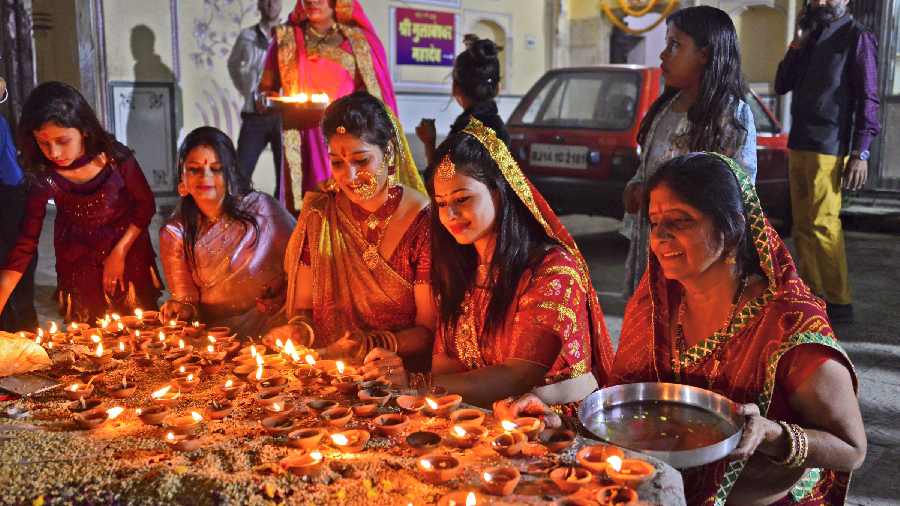 Devotees light earthen lamps at Ramchandra Ji temple on the occasion of Diwali, in Jaipur