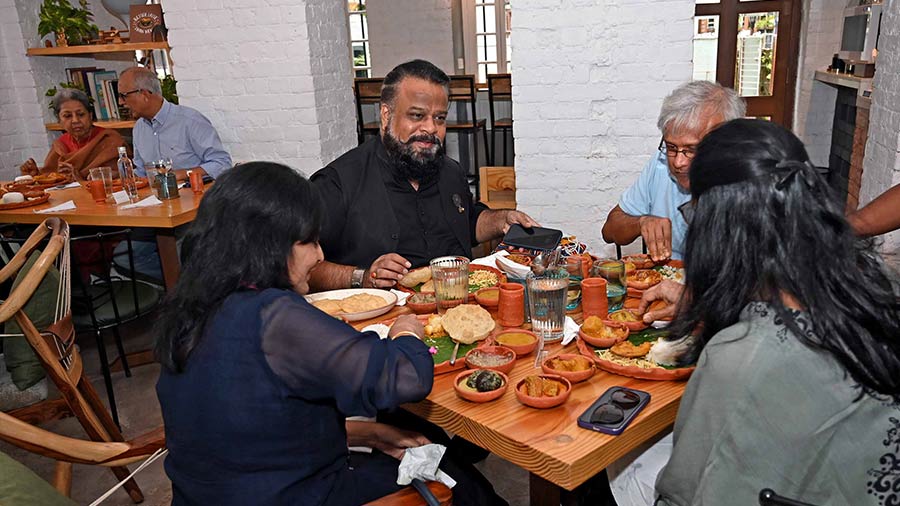 Filmmaker Rajesh Gupta (in black) and other guests enjoying the spread