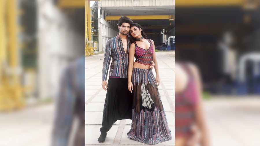 Iqbal sported a smart fusion look in a printed bomber jacket with tape detailing and paired it with low-crotch pants. Juhi Ghosh complemented the frame in a sheer French knot-embroidered blouse, teamed with an embroidered lehnga designed with sheer panels.