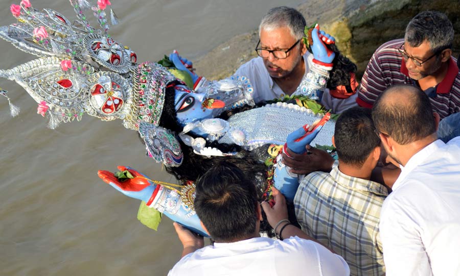An idol of Goddess Kali being immersed at Babughat