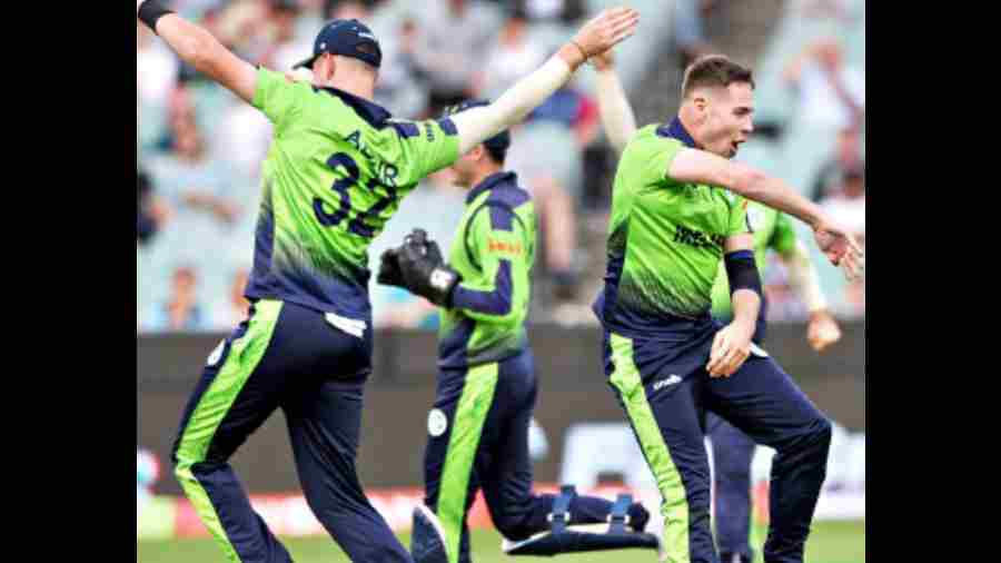 Ireland’s Josh Little celebrates with Mark Adair (No.32 shirt) after dismissing England captain Jos Buttler in Melbourne on Wednesday