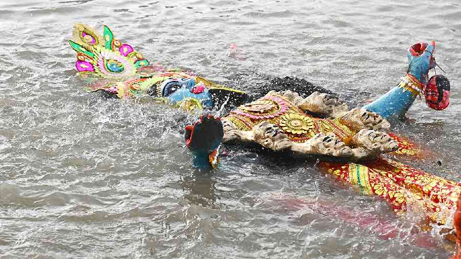 A Kali idol being immersed in the Hooghly at Baje Kadamtala Ghat on Wednesday. 