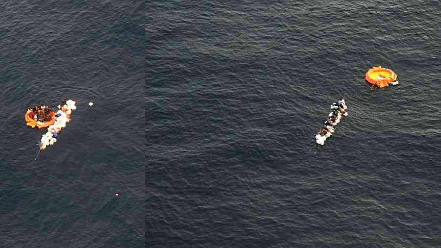 The Bangladeshi fishermen who were clinging to floats and wooden planks swim towards the life raft dropped from an Indian Coast Guard Dornier aircraft