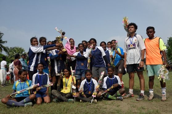 Students from an all-girls football academy winning the first prize award