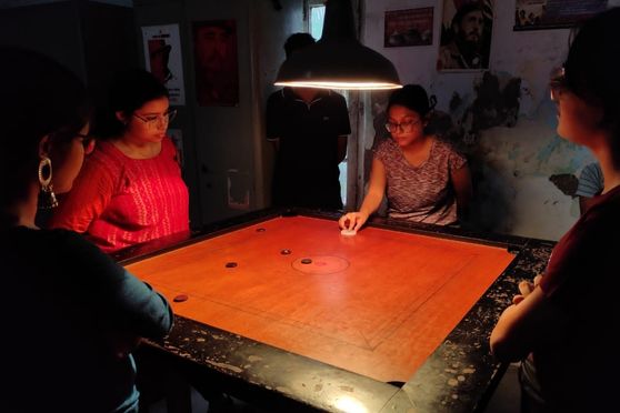 Students participating in the game of carrom 