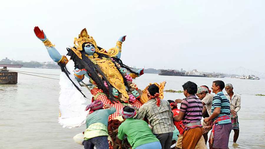 A Kali idol being immersed in the Hooghly at Baje Kadamtala Ghat on Thursday afternoon. 