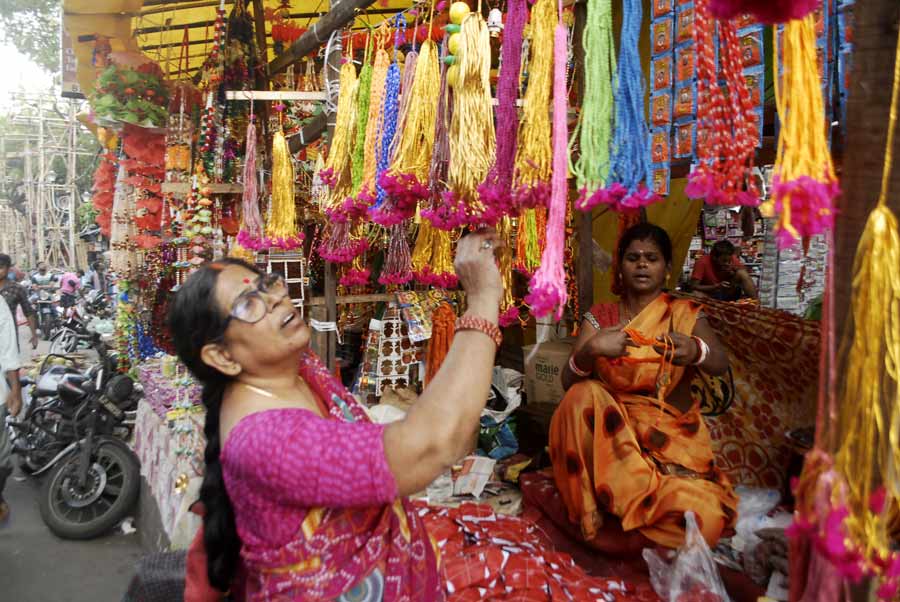 A woman negotiates with a shopkeeper on the first day of Chhath Puja. The four-day festival began on Friday.