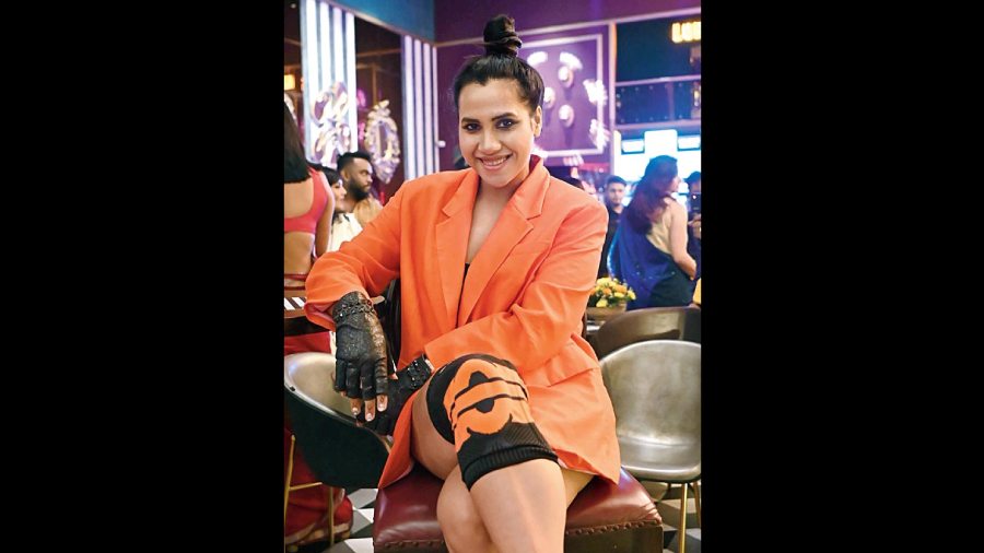 Nikhita Gandhi channelled a smart look in a neon orange blazer dress