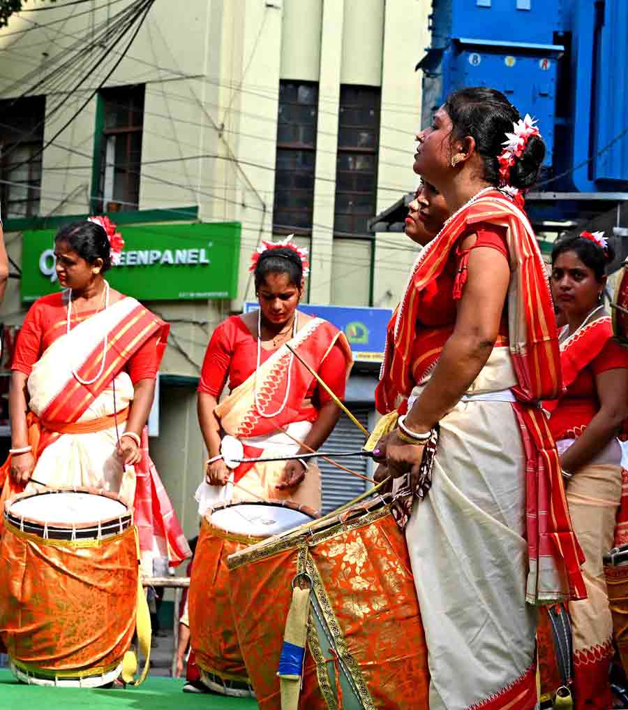 Women dressed in traditional attire showcase their skills.