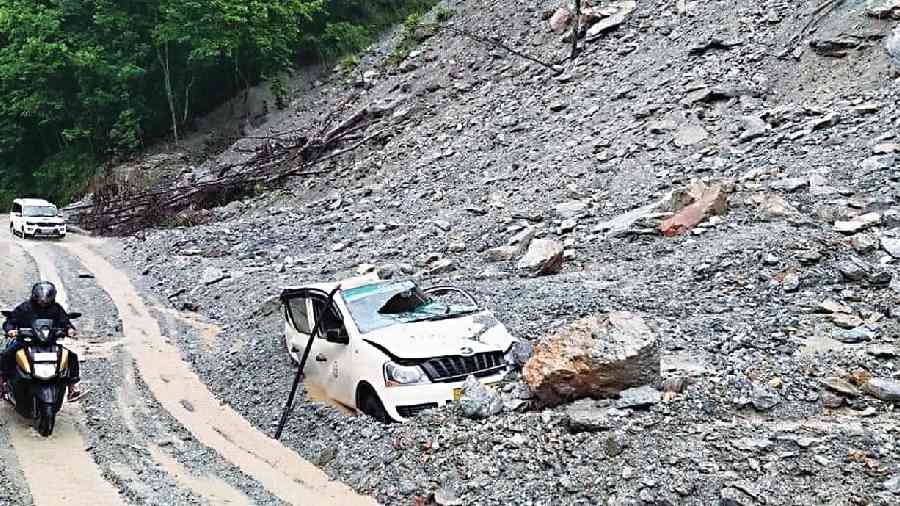 An SUV damaged by debris following a landslide that occurred along NH10 at 20th Mile in Sikkim on Wednesday night