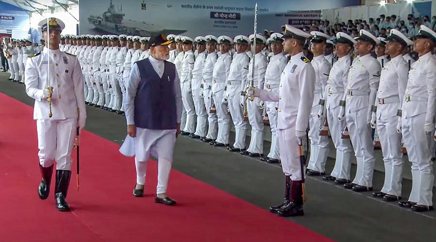 Prime Minister Narendra Modi inspects a Guard of Honour during the commissioning ceremony of the first indigenously designed and built aircraft carrier, INS Vikrant, at Cochin Shipyard Limited in Kochi