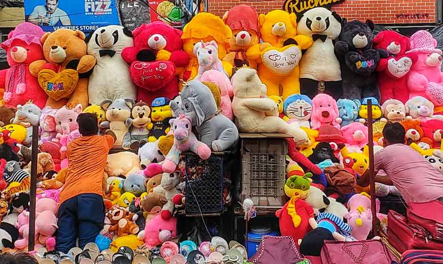 Shopkeepers adjust soft toys at their stall at Esplanade on Friday.