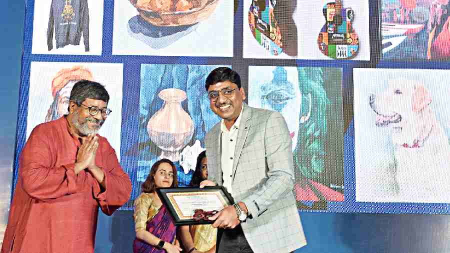 Manoj Agarwal, company secretary and general manager (legal) of the Balrampur Chini Mills, “presents and accepts” the Balrampur Chini Mills Award for Outstanding  Talent (art), on behalf of Abhinav Duttagupta, a Class XII student of The NewTown School. Abhinav could not  make it to the ceremony. When Agarwal said his daughter  is in the same school, Biswanath Dasgupta, founder-member of The Telegraph Education Foundation, requested him  to accept the award 