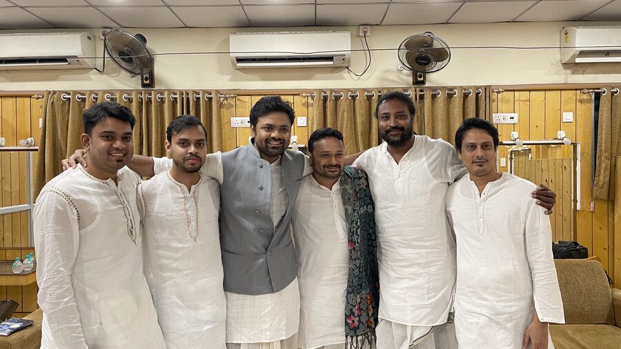 Sourendro and Soumyojit with their band in all white 