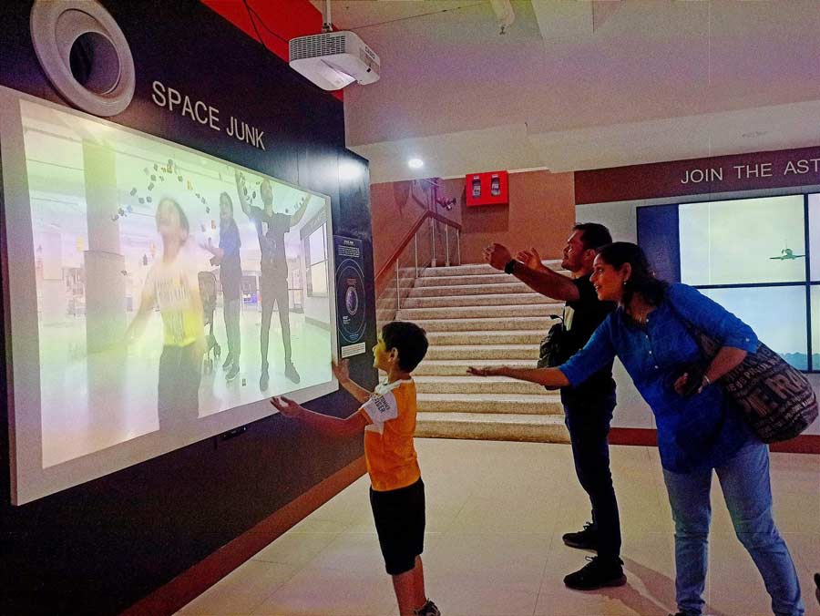 Visitors at the interactive exhibit ‘Space Junk’ at Science City in Kolkata on Tuesday.