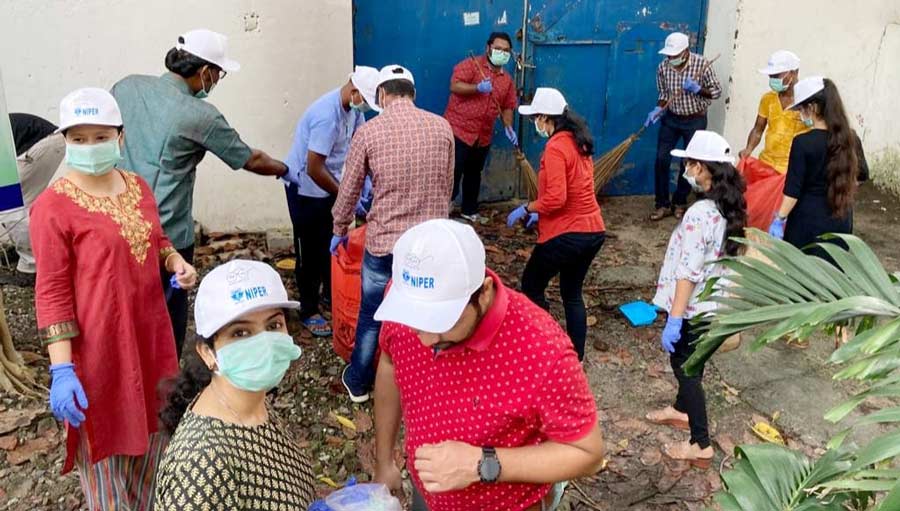 Students and faculty members of the  National Institute of Pharmaceutical Education and Research, Kolkata, carry out a cleanliness drive as a part of Swachhta Pakhwada Campaign on Tuesday.