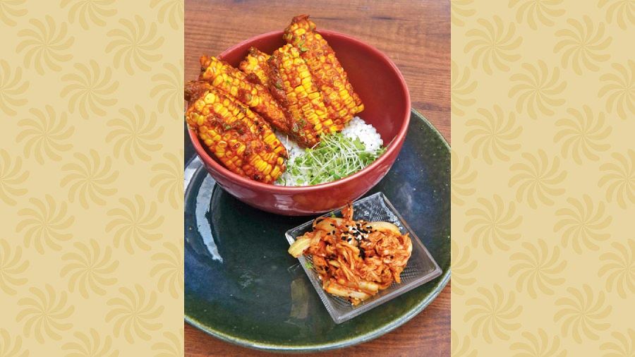Corn Ribs: Marinated with Thai herbs and togarashi sauce, the corn cobs are fried and served on a bed of sago and served with microgreens.