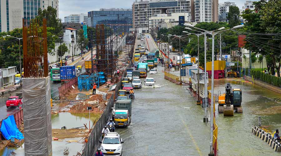 Vehicles wade through the waterlogged Outer Ring Road after heavy monsoon rains in Bellandur, Bengaluru.