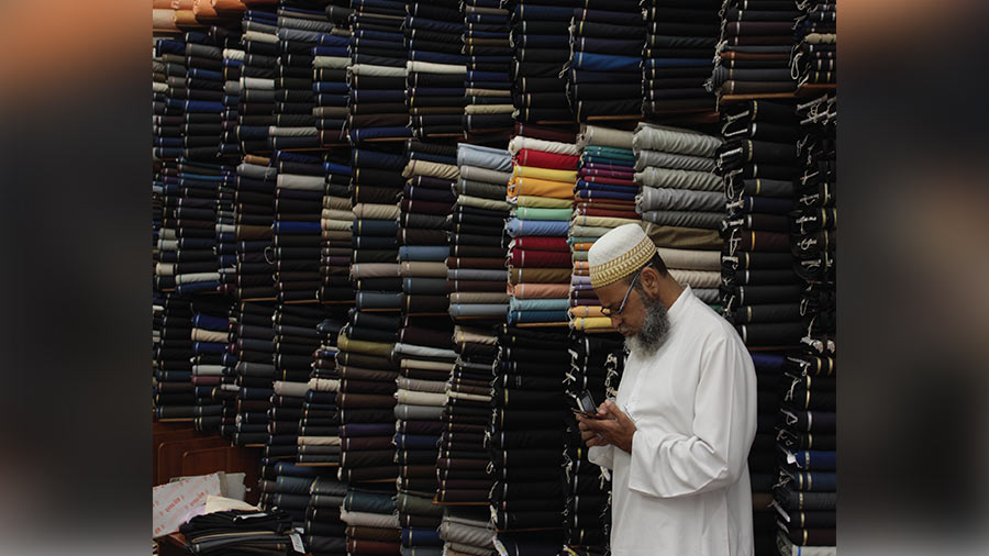 Piles of textile inside the shop, almost forming a wall of fabric