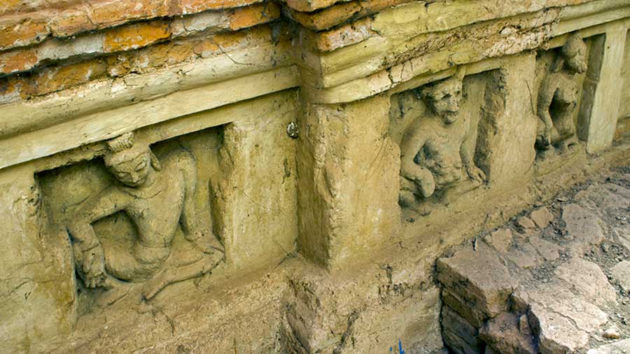 Stucco work and human figures grace the walls of the excavated ruins