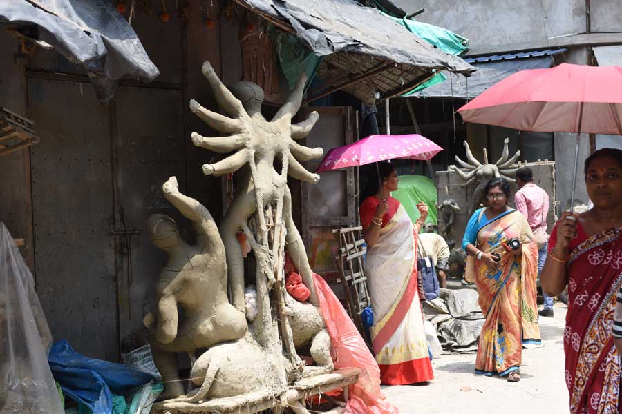 Artisans at Kumartuli place clay models of Durga in the sun on Thursday. There was some relief in the evening from the scorching heat following a smart shower at some places.