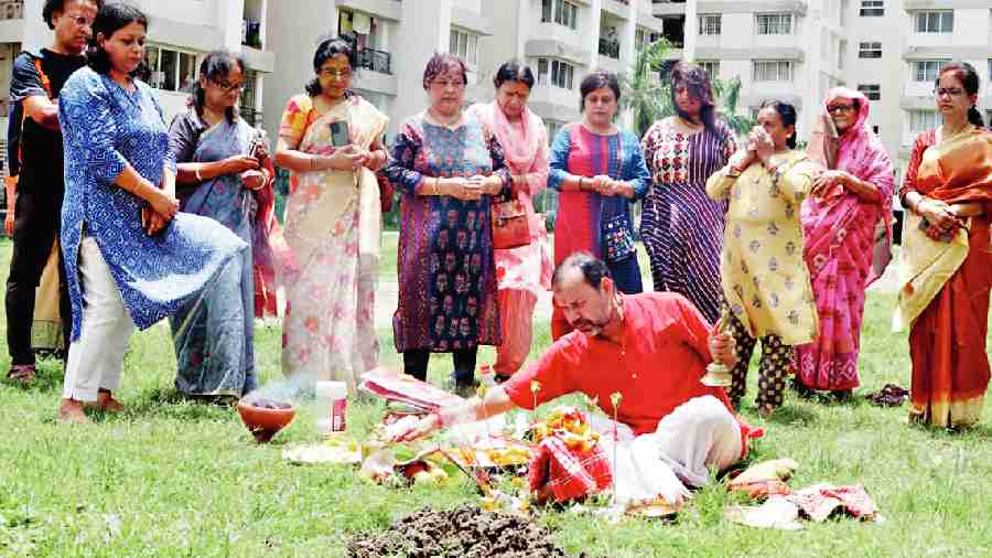 A priest performs puja while Silver Oak Estate residents watch