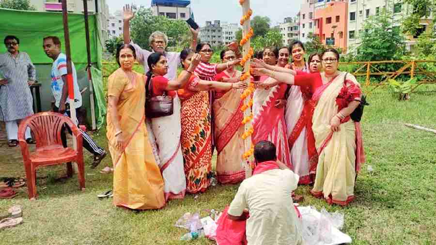 Residents of CA Block in New Town pose with the khuti after the puja