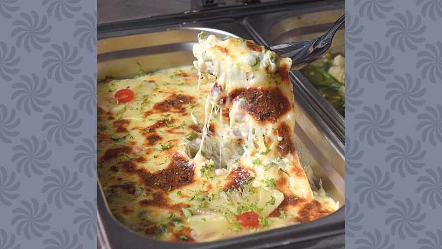 Vegetable Au Gratin: It is a French dish made with mixed vegetables, white sauce base and cheese. It is creamy with a perfect crust.
