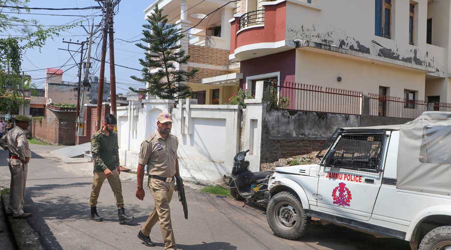 Police personnel deployed during a search by Central Bureau of Investigation (CBI) officials in connection with alleged irregularities in the recruitment process of sub-inspectors in the Union Territory, in Jammu, Tuesday, Sept. 13, 2022. The search operation was started at 33 locations. 