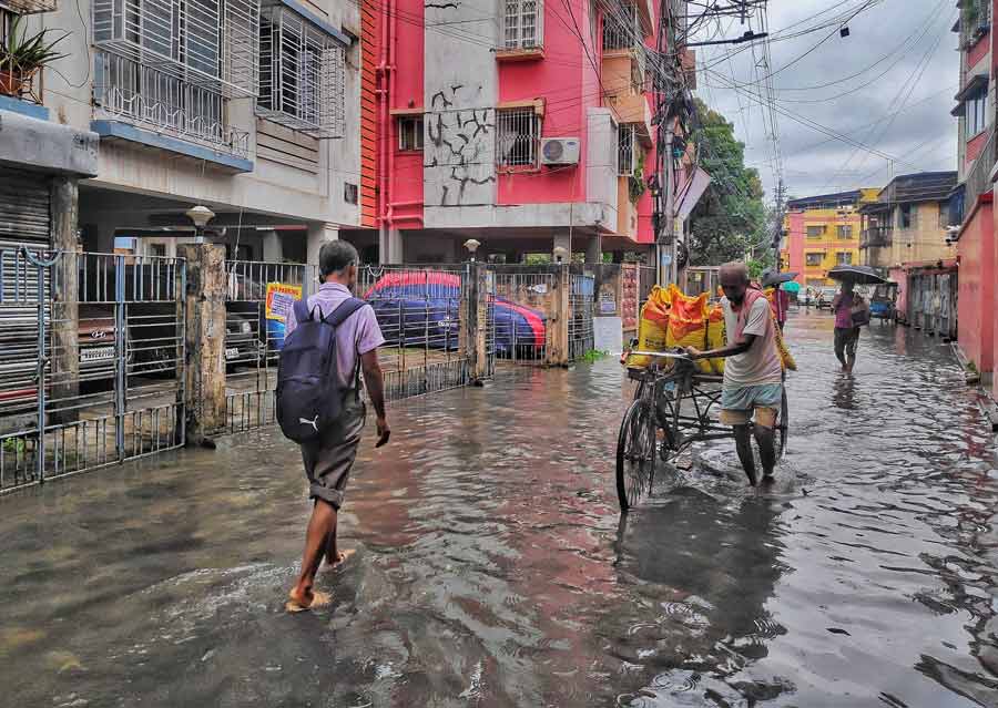 A waterlogged street in a south Kolkata neighbourhood. The depression that triggered the showers has weakened into a “well-marked low-pressure area”, according to the weather bulletin