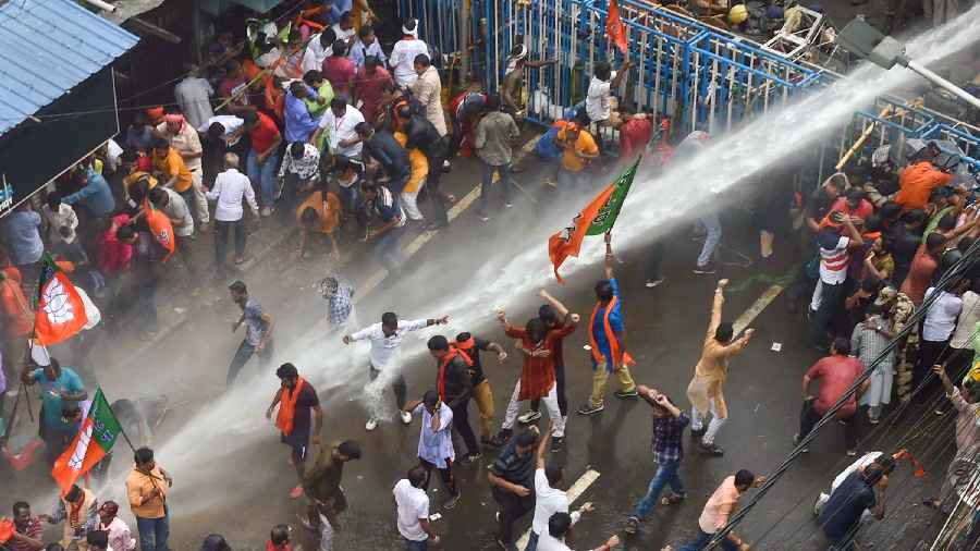 Security personnel use water cannons 