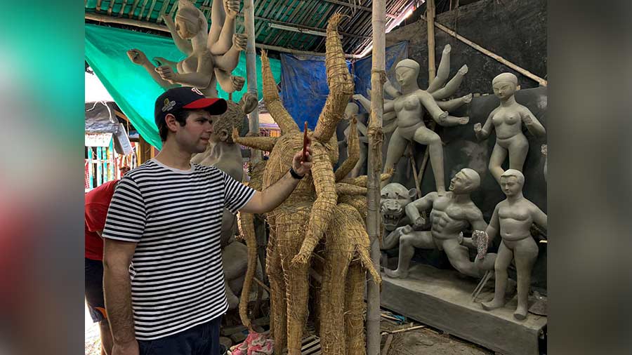 Matthew Bikoff captures half-finished idols on his mobile camera during a visit to Kumartuli.